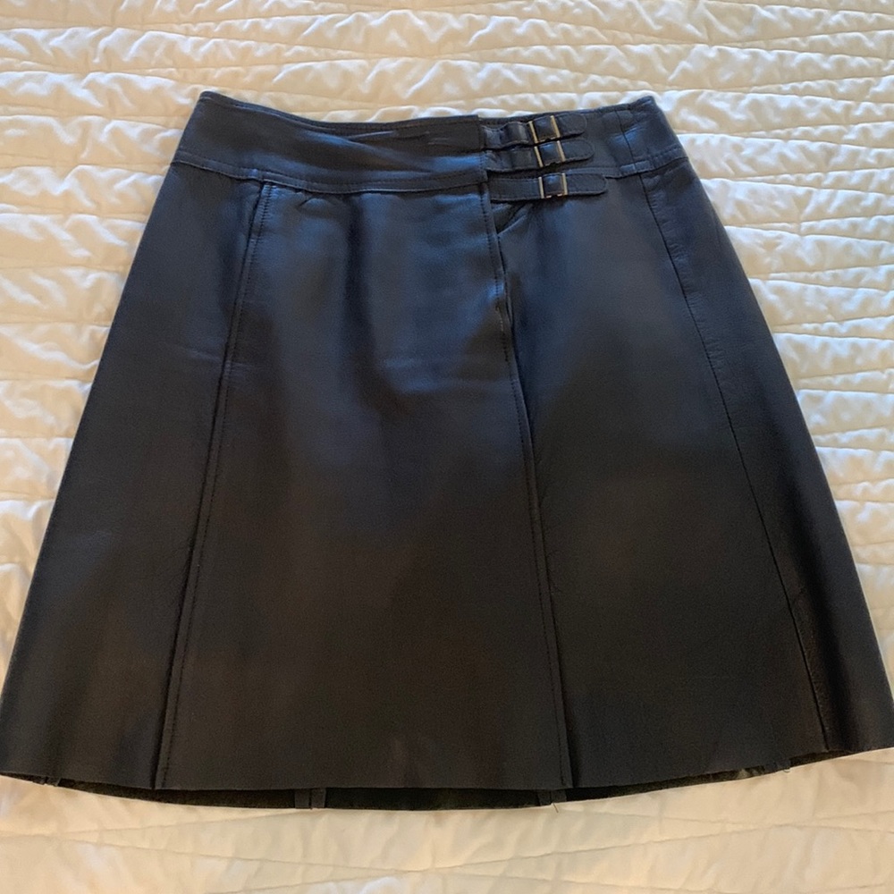 Unmarked dark brown midi leather skirt.